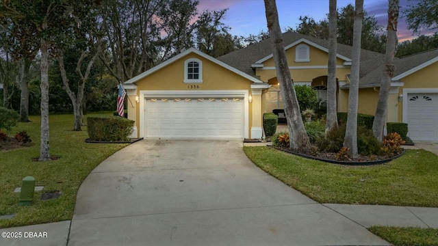 view of front of house featuring a yard and a garage