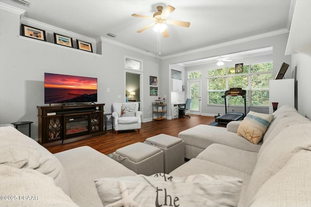 living room featuring ceiling fan, crown molding, and dark hardwood / wood-style floors