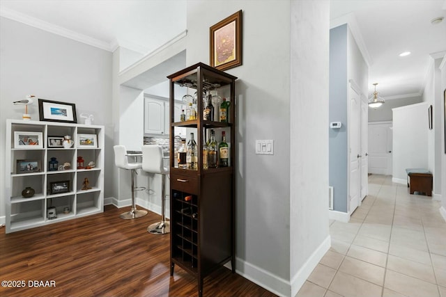 hallway with tile patterned floors and ornamental molding