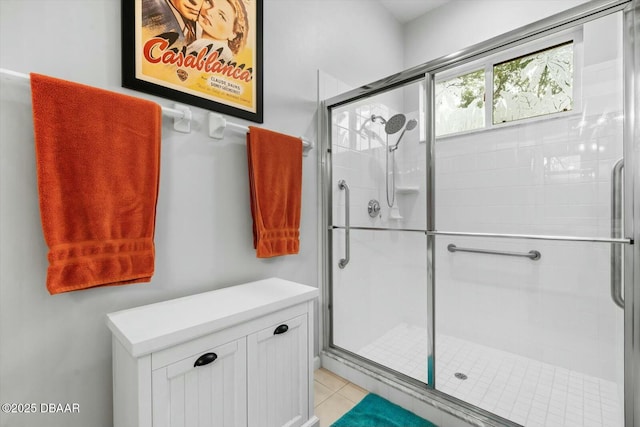 bathroom featuring tile patterned flooring and an enclosed shower