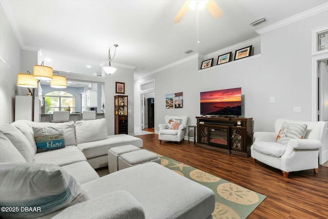 living room featuring dark hardwood / wood-style floors, ceiling fan, and ornamental molding