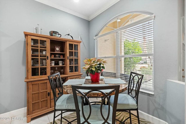 dining room featuring light tile patterned floors, crown molding, and a healthy amount of sunlight