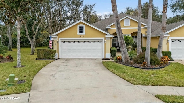 view of front of property featuring a front yard and a garage