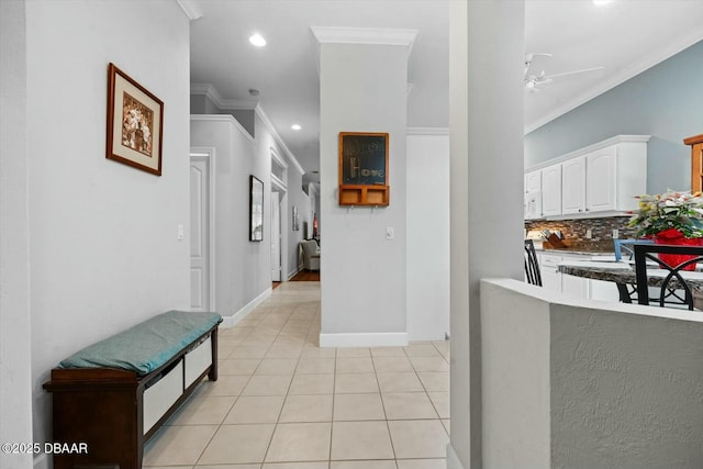 corridor with crown molding and light tile patterned flooring