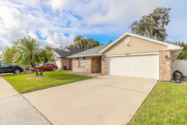 ranch-style home with a garage and a front lawn