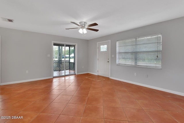 foyer entrance with baseboards, visible vents, ceiling fan, and light tile patterned flooring