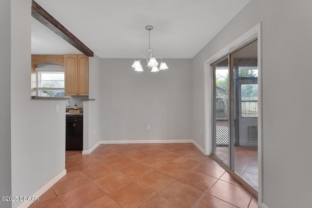 unfurnished dining area featuring a chandelier, light tile patterned flooring, and baseboards