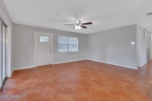 entrance foyer featuring light tile patterned floors, baseboards, and a ceiling fan