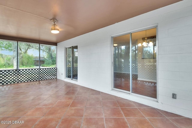 unfurnished sunroom with a chandelier