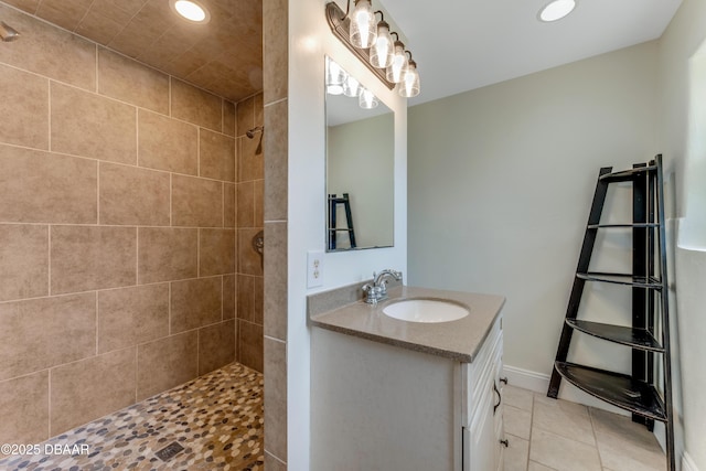 556 N Beach St, Ormond Beach, FL 32174 - bathroom featuring vanity, tiled shower, tile patterned floors, recessed lighting, and baseboards