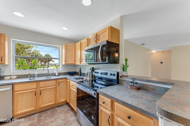 556 N Beach St, Ormond Beach, FL 32174 - kitchen featuring appliances with stainless steel finishes, light brown cabinets, a sink, recessed lighting, and dark countertops