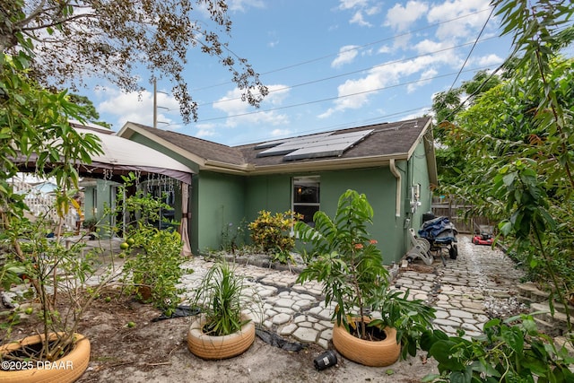 exterior space with a patio area and solar panels