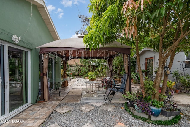 view of patio with a gazebo and an outbuilding