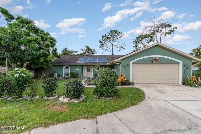 ranch-style home with a front yard, solar panels, and a garage