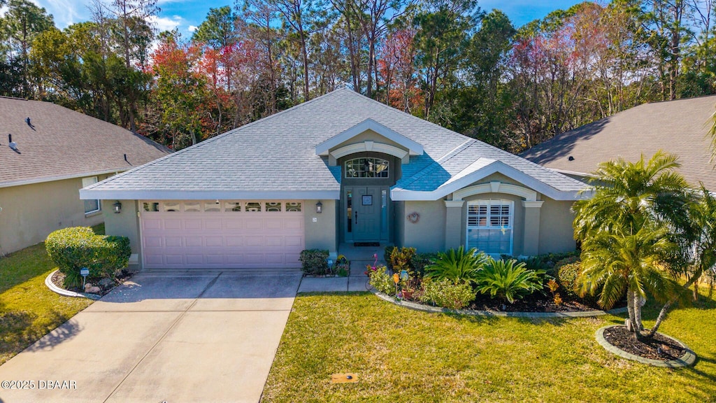 view of front of property featuring a garage and a front lawn