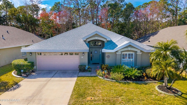 view of front of property featuring a garage and a front lawn