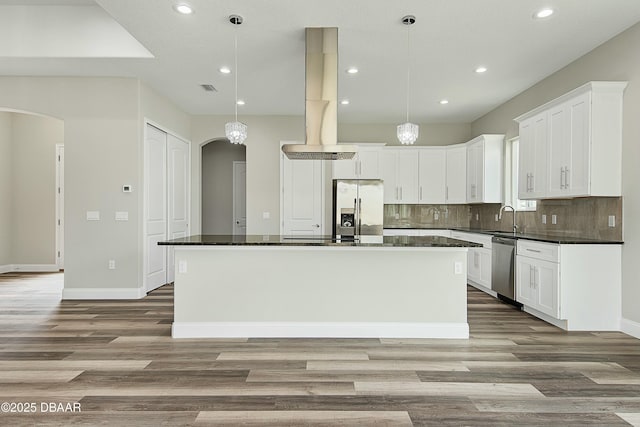 kitchen featuring hanging light fixtures, a center island, and appliances with stainless steel finishes