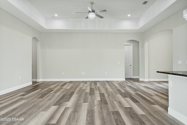 unfurnished living room featuring ceiling fan and light hardwood / wood-style floors