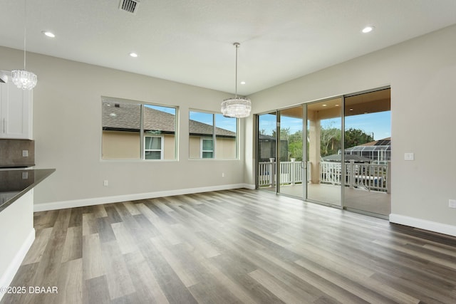 interior space with hardwood / wood-style flooring and a notable chandelier