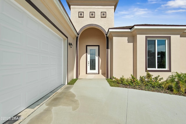 view of exterior entry with a garage