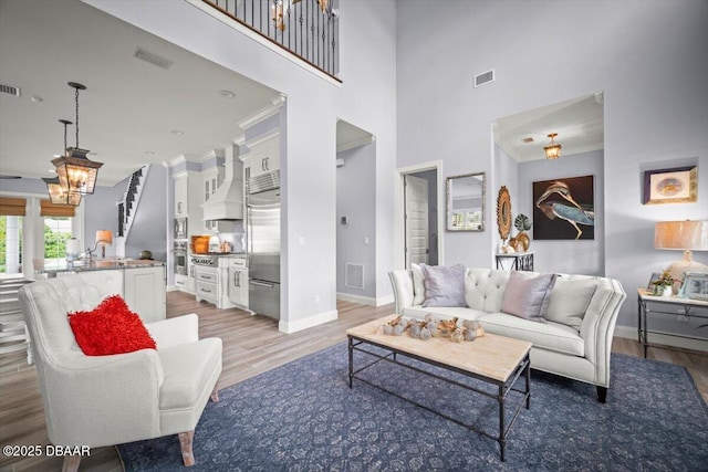 96 Grove St, Ormond Beach, FL 32174 - living area with light wood-style flooring, baseboards, and a towering ceiling