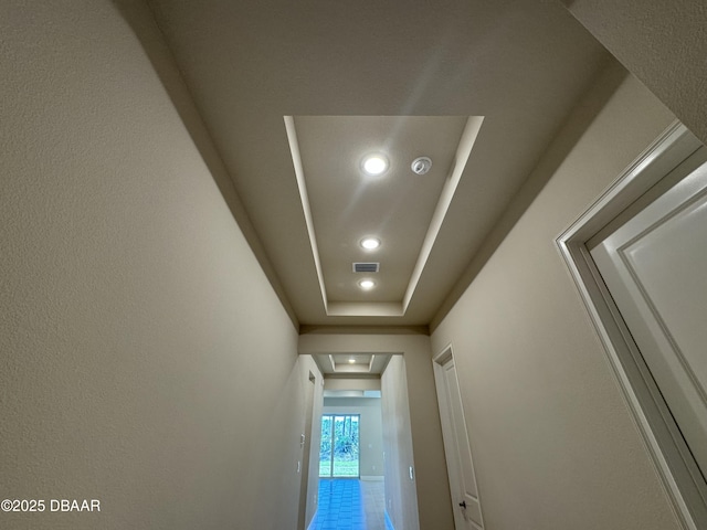 room details with a tray ceiling, recessed lighting, and visible vents