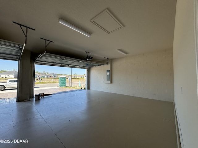 garage featuring electric panel and a garage door opener