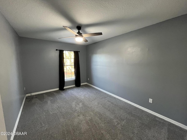 carpeted spare room with ceiling fan and a textured ceiling