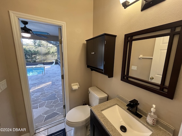 bathroom featuring tile patterned floors, ceiling fan, vanity, and toilet