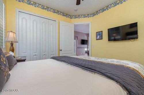 bedroom featuring ceiling fan and a closet