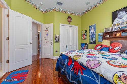 bedroom with hardwood / wood-style floors and a closet