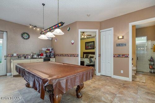 recreation room featuring a textured ceiling and pool table