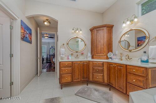 bathroom with tile patterned floors, vanity, and ceiling fan