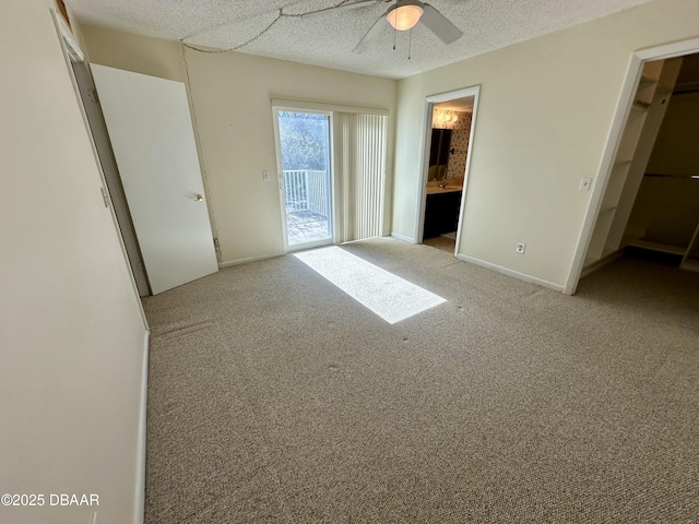 4150 S Atlantic Ave Unit 102B, New Smyrna Beach, FL 32169 - unfurnished bedroom featuring access to exterior, carpet floors, a ceiling fan, ensuite bathroom, and a textured ceiling