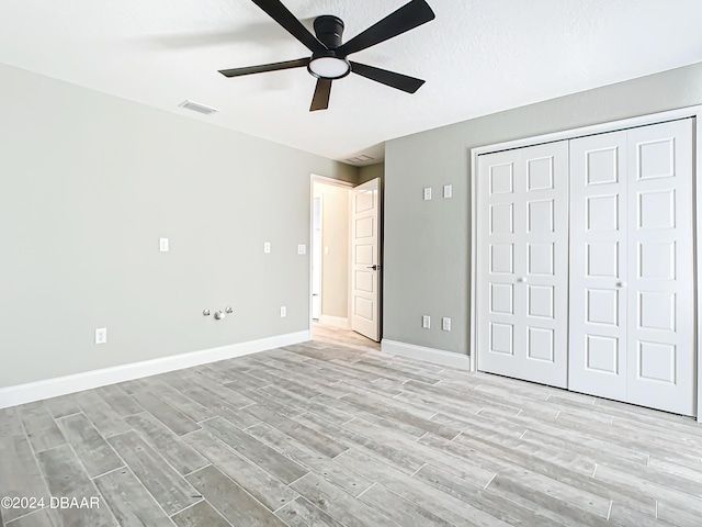 154 Capri Dr, Ormond Beach, FL 32176 - unfurnished bedroom with a closet, ceiling fan, and light hardwood / wood-style flooring
