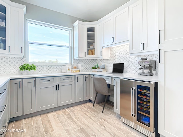 154 Capri Dr, Ormond Beach, FL 32176 - kitchen featuring wine cooler, backsplash, gray cabinetry, and white cabinets