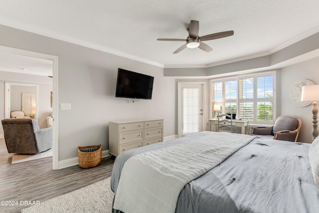 bedroom with hardwood / wood-style floors, ceiling fan, a textured ceiling, and ornamental molding