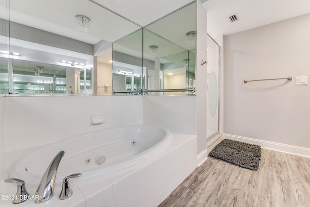 bathroom featuring shower with separate bathtub and hardwood / wood-style floors