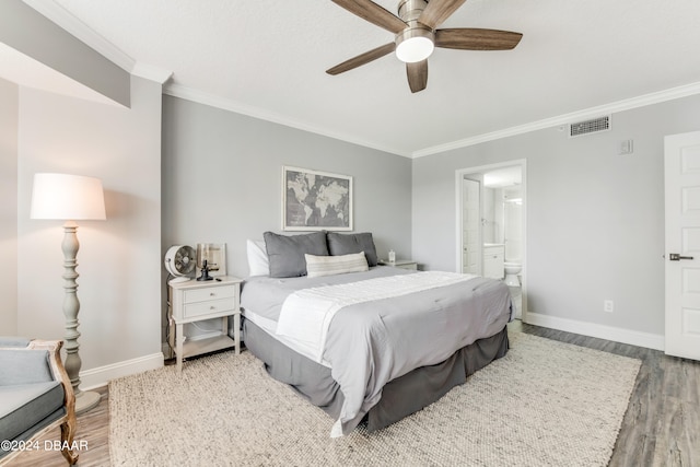 bedroom featuring hardwood / wood-style flooring, ornamental molding, ceiling fan, and connected bathroom