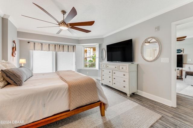 bedroom featuring hardwood / wood-style flooring, ceiling fan, and ornamental molding