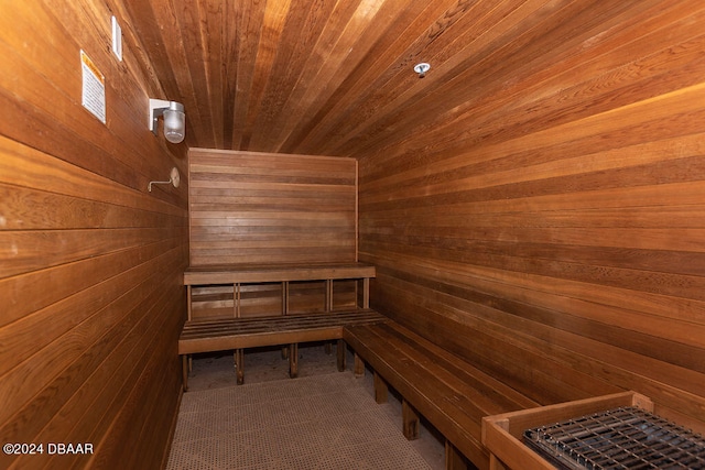 view of sauna / steam room with wooden walls and wood ceiling