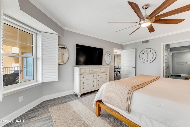 bedroom with ornamental molding, wood-type flooring, and ceiling fan