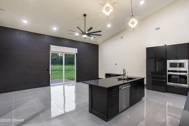 kitchen featuring sink, high vaulted ceiling, a center island with sink, light tile patterned floors, and stainless steel appliances