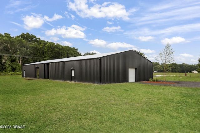 view of outbuilding featuring a garage and a lawn