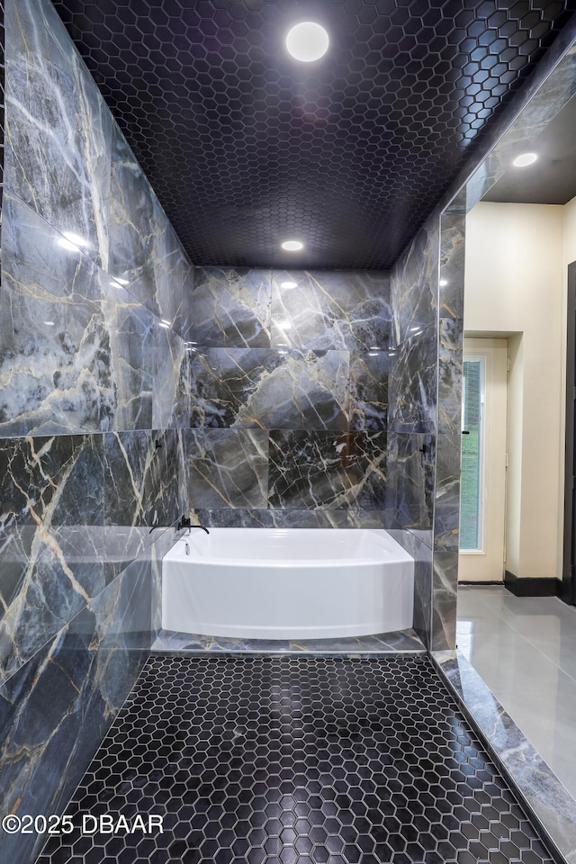 bathroom with tile patterned flooring and a bathtub