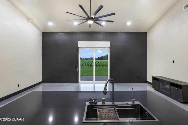 kitchen featuring sink, light tile patterned floors, and ceiling fan