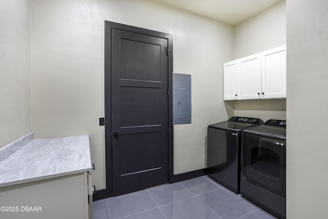 clothes washing area with cabinets, tile patterned floors, electric panel, and washer and dryer