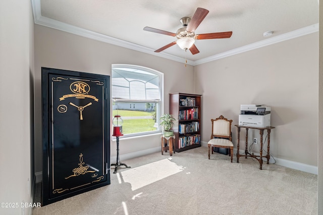 living area featuring carpet, crown molding, a ceiling fan, and baseboards