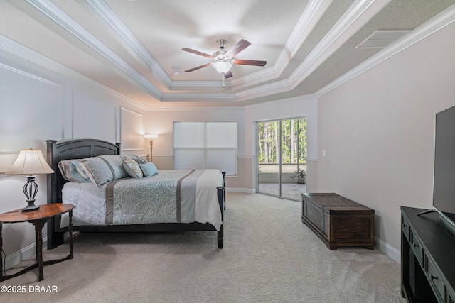 bedroom with crown molding, a raised ceiling, light carpet, and a ceiling fan