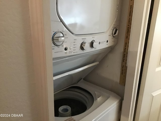 laundry area featuring stacked washer / dryer